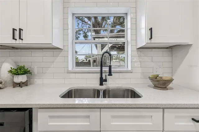 a living room with furniture a dining table and a chandelier