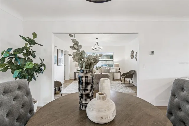 an empty room with wooden floor ceiling fan and windows