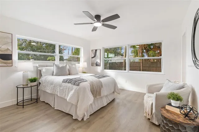 a white house that has a tree in front of it