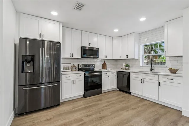 a view of a dining room with furniture wooden floor and chandelier
