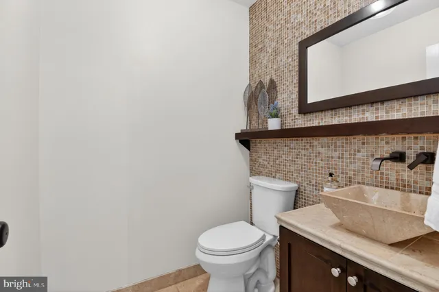a view of a hallway with wooden floor and stairs