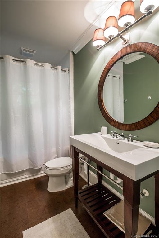 2141 Sagamore Road Charlotte, NC 28209 - Photo 16 of 24 a bathroom with a sink toilet and a mirror