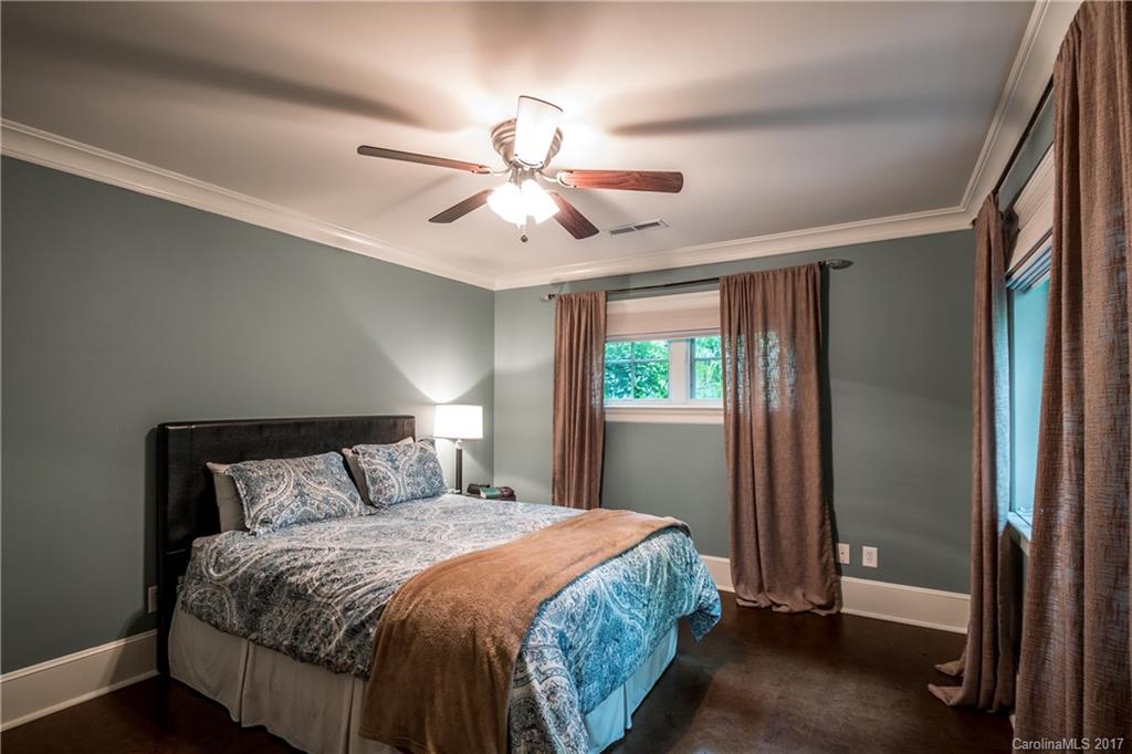 2141 Sagamore Road Charlotte, NC 28209 - Photo 17 of 24 a bedroom with a large bed and a chandelier