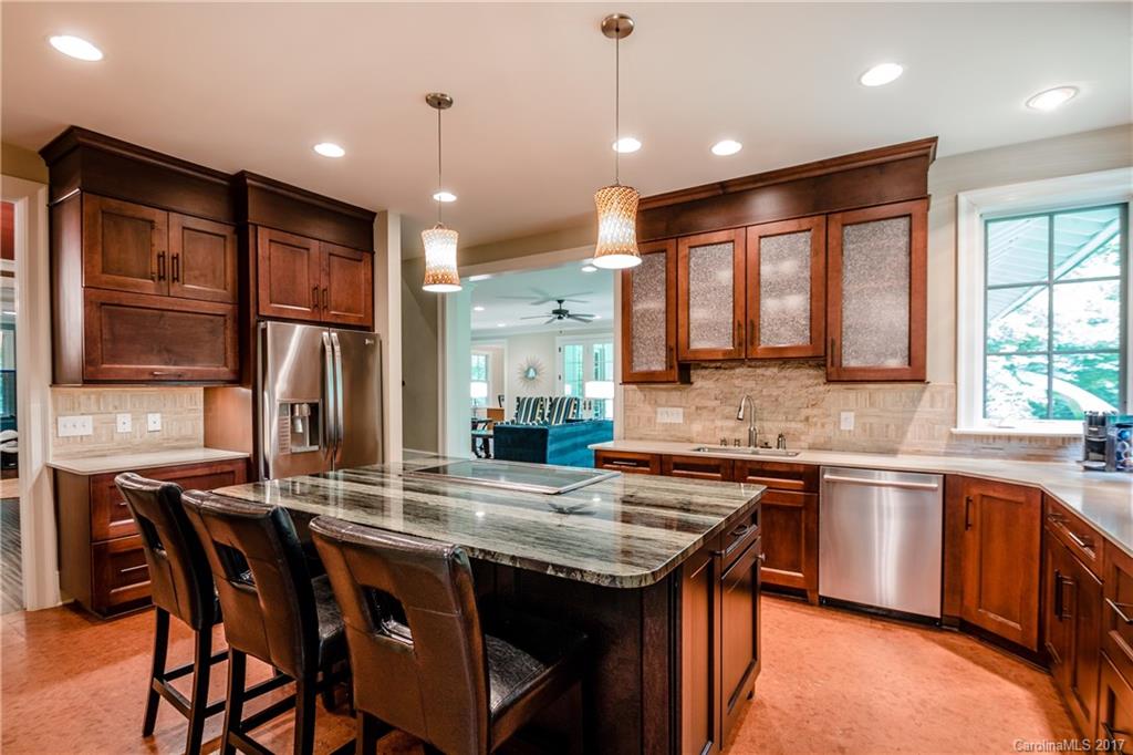 2141 Sagamore Road Charlotte, NC 28209 - Photo 3 of 24 a kitchen with stainless steel appliances granite countertop wooden cabinets and a stove top oven