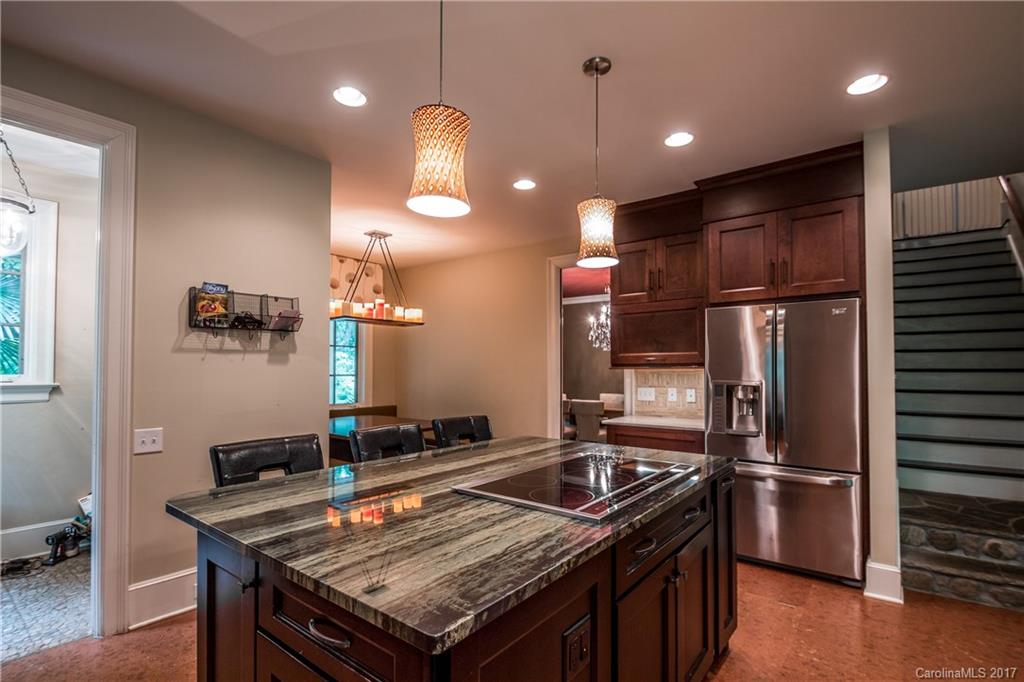 2141 Sagamore Road Charlotte, NC 28209 - Photo 4 of 24 a kitchen with a stove a refrigerator and a microwave