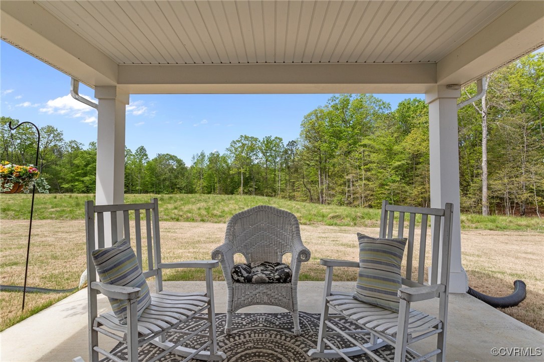 a view of a patio with a table chairs and backyard