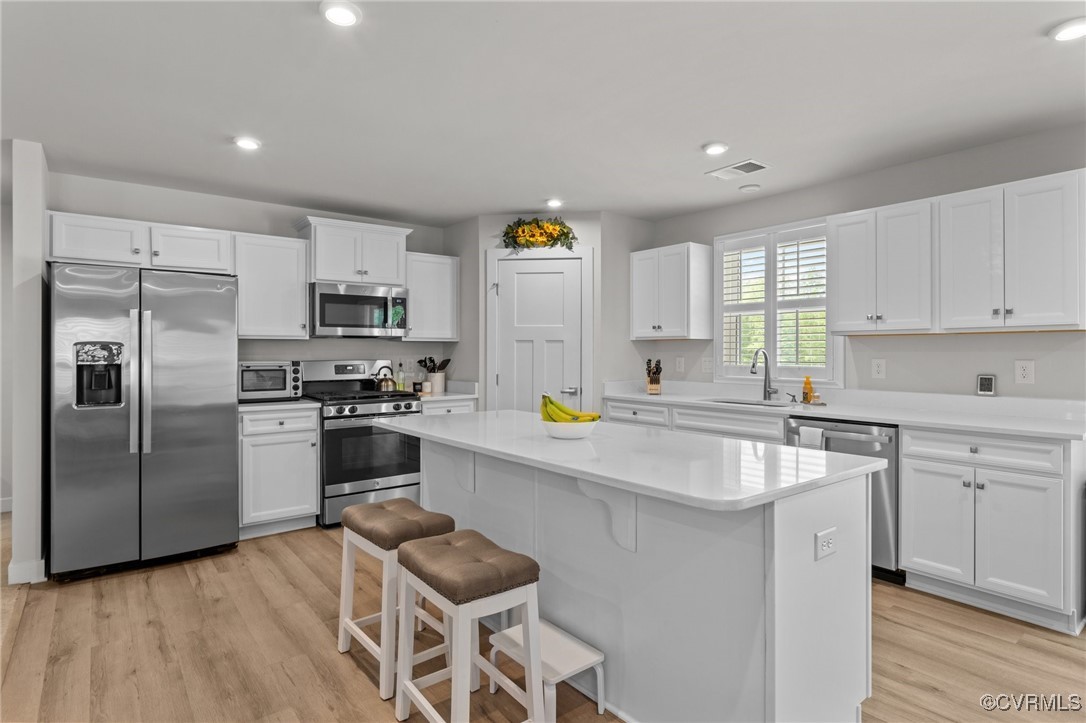 8106 West Danube Loop New Kent, VA 23124 - Photo 14 of 48 a kitchen with a refrigerator and a stove top oven