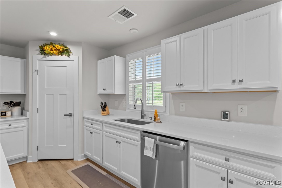 8106 West Danube Loop New Kent, VA 23124 - Photo 17 of 48 a kitchen with white cabinets and a sink
