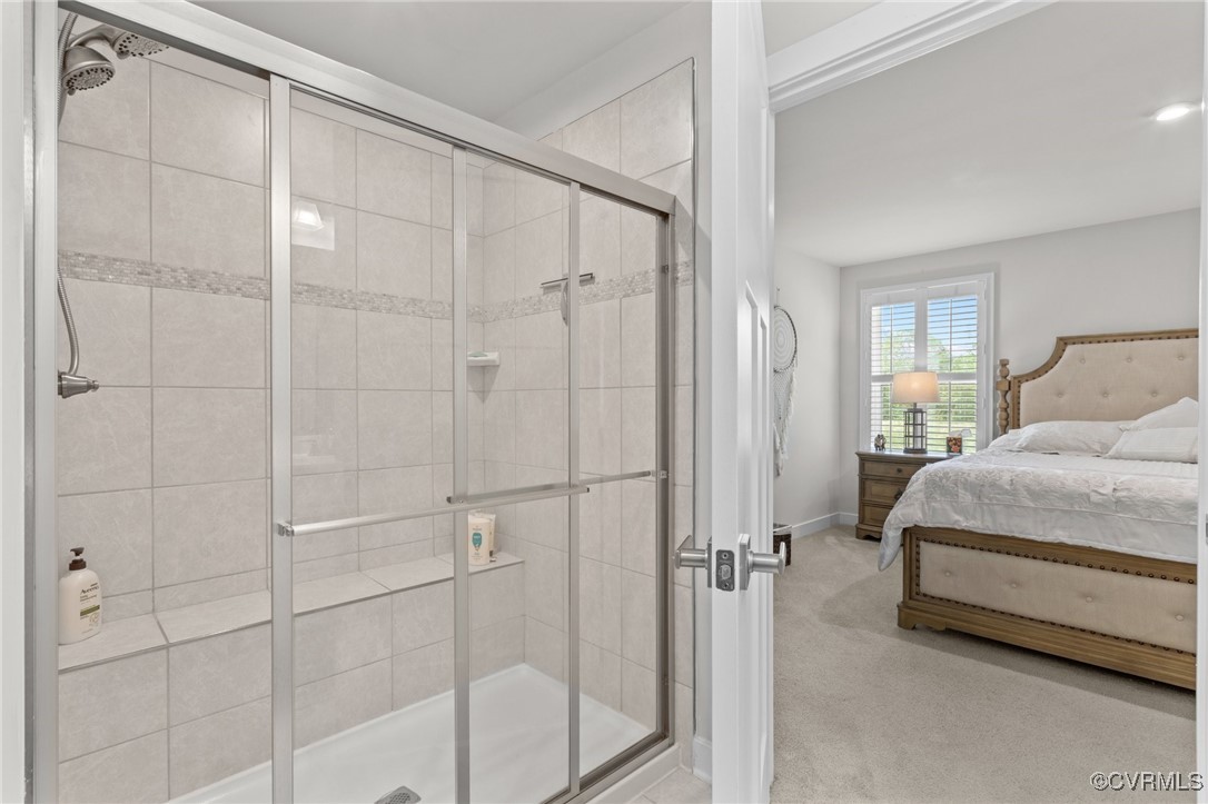 8106 West Danube Loop New Kent, VA 23124 - Photo 22 of 48 a spacious bedroom with a bed and a shower