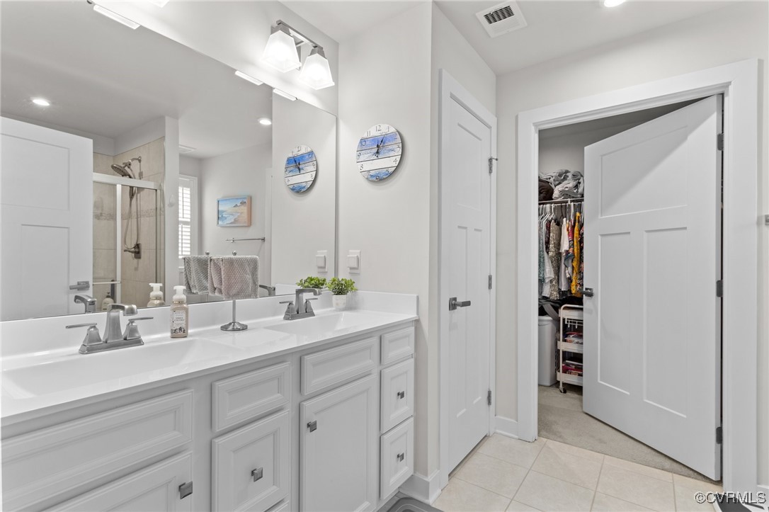 8106 West Danube Loop New Kent, VA 23124 - Photo 23 of 48 a spacious bathroom with a double vanity sink and a mirror
