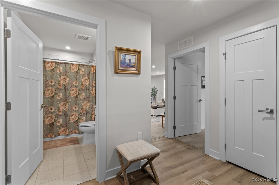 8106 West Danube Loop New Kent, VA 23124 - Photo 30 of 48 a view of a livingroom with wooden floor and a bathroom