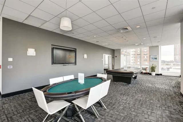 a dining room with furniture and a large window