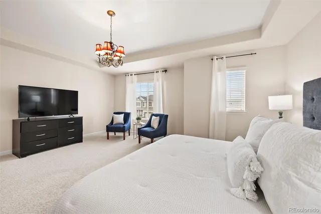 a bedroom with furniture and a flat screen tv