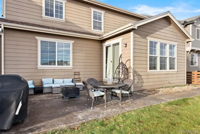 a view of a house with a patio and a yard