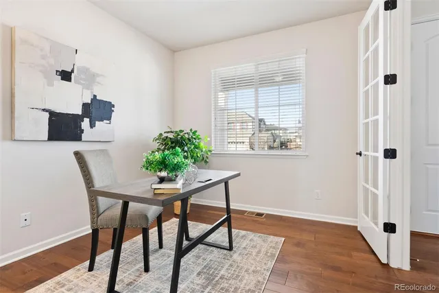 a view of a workspace with furniture and a window