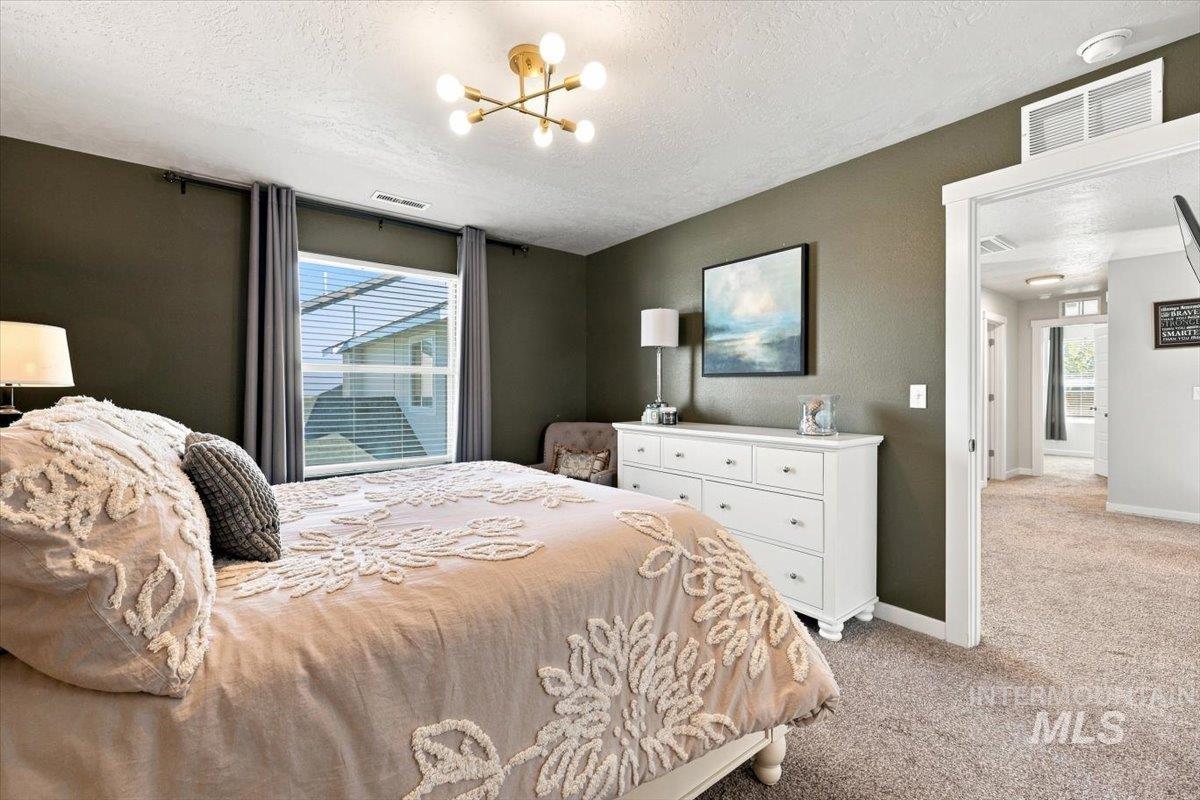 696 East Springloyd Street Meridian, ID 83642 - Photo 22 of 37 Recessed window with blinds, overhead brass-finish light fixture, and carpeted flooring