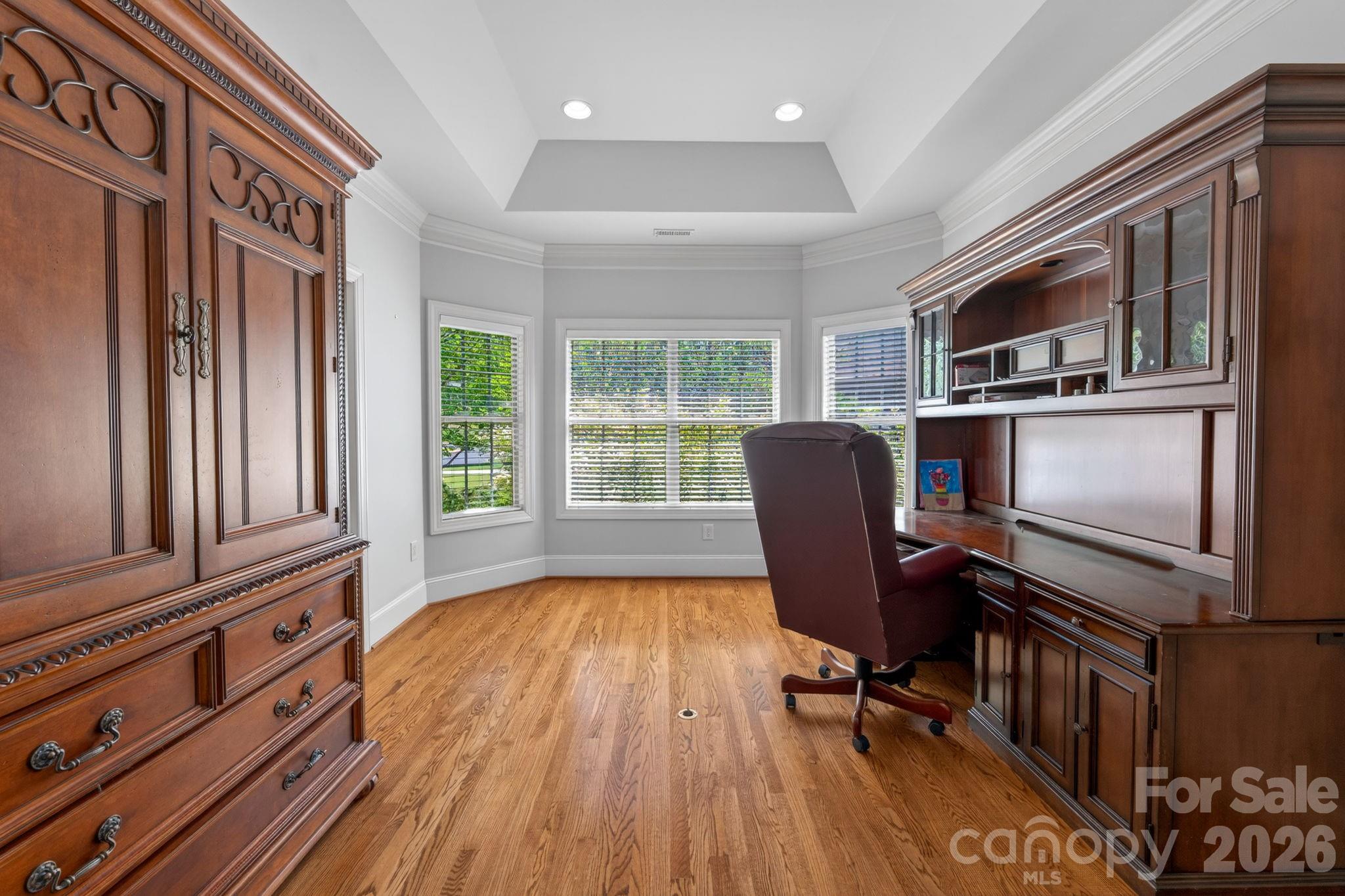 3138 Rappahannock Court, Unit 16 Matthews, NC 28104 - Photo 28 of 38 a workspace with wooden floor and furniture