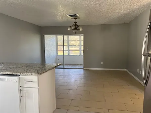 a view of a kitchen with a sink and dishwasher cabinets