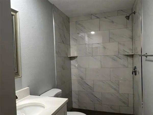 a bathroom with a toilet and shower