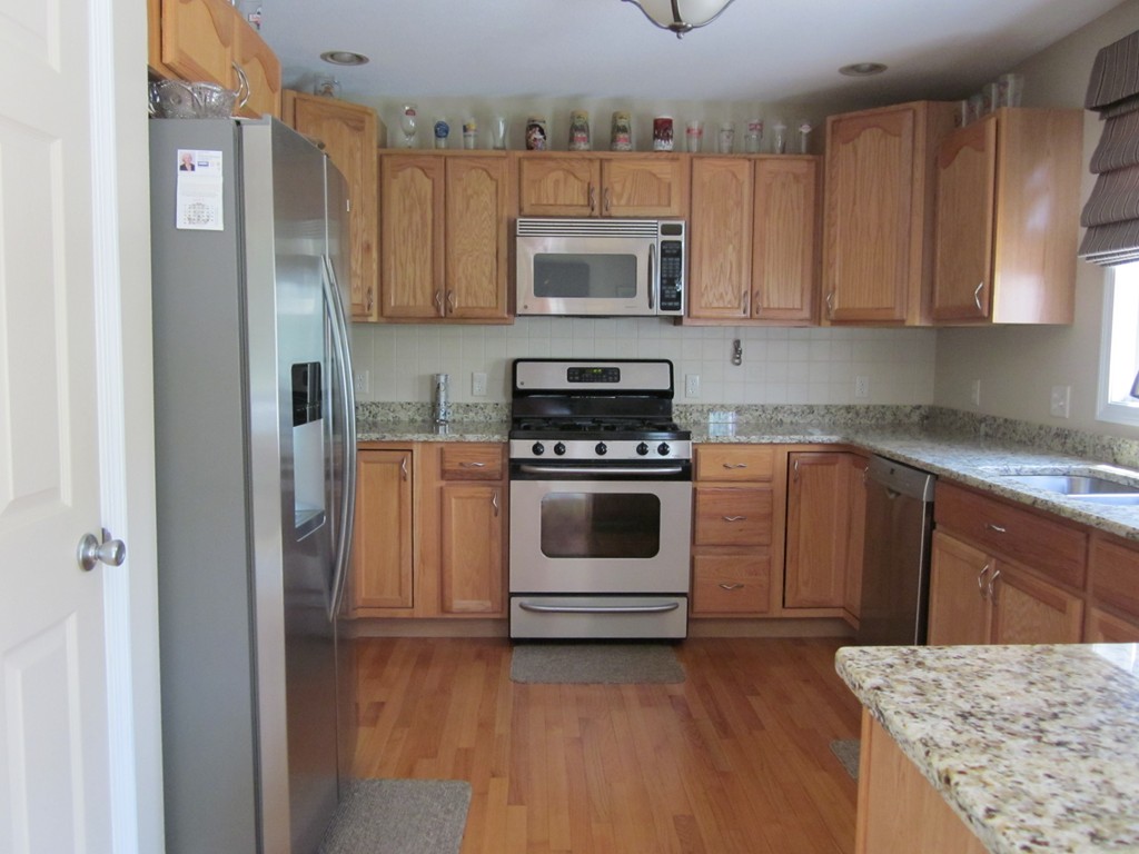 5 Woodland Road Springfield, MA 01129 - Photo 13 of 30 a kitchen with white cabinets and white appliances