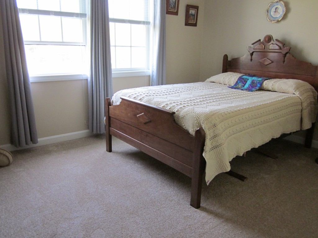 5 Woodland Road Springfield, MA 01129 - Photo 17 of 30 a bed sitting in a bedroom next to a window