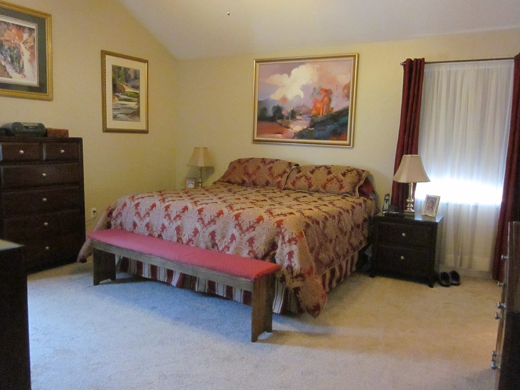 5 Woodland Road Springfield, MA 01129 - Photo 18 of 30 a large bed sitting in a bedroom next to a cabinet