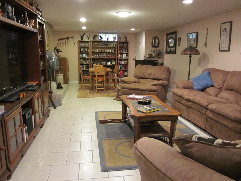 5 Woodland Road Springfield, MA 01129 - Photo 22 of 30 a living room with furniture gym equipment and a flat screen tv