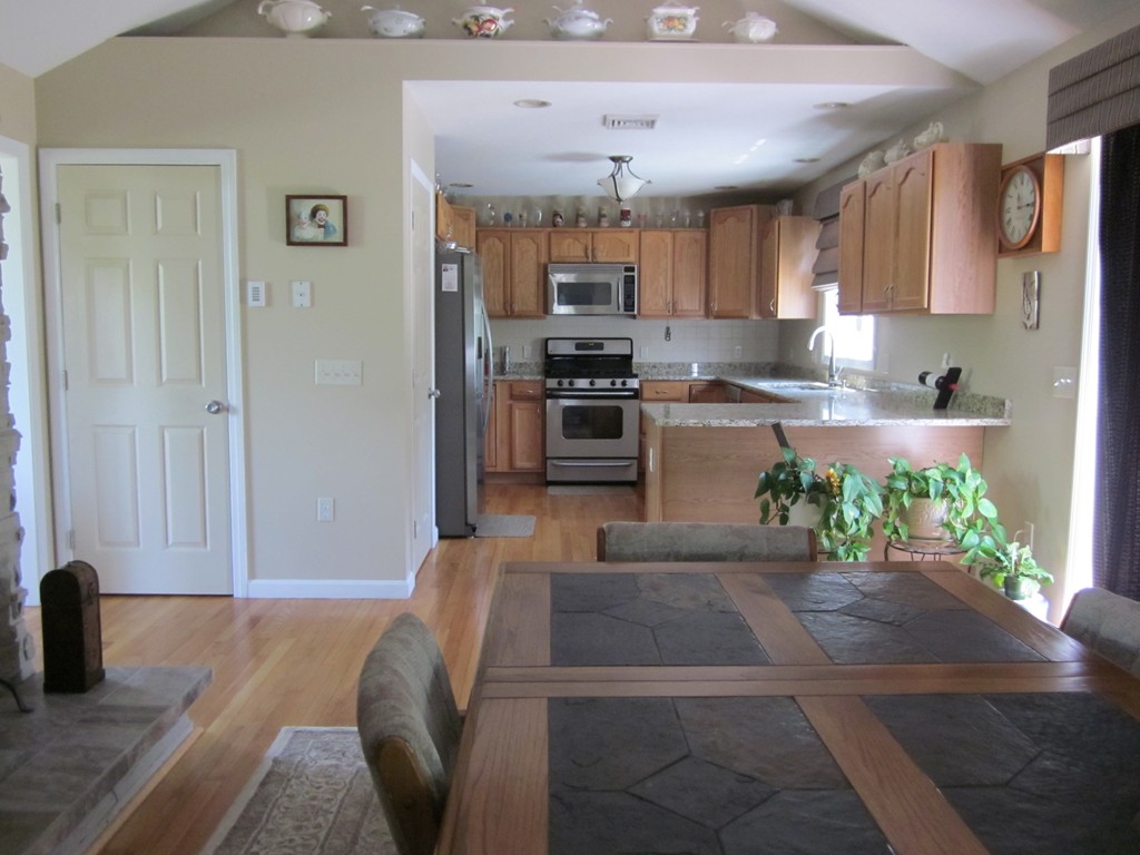 5 Woodland Road Springfield, MA 01129 - Photo 10 of 30 a kitchen with stainless steel appliances kitchen island granite countertop a refrigerator and stove