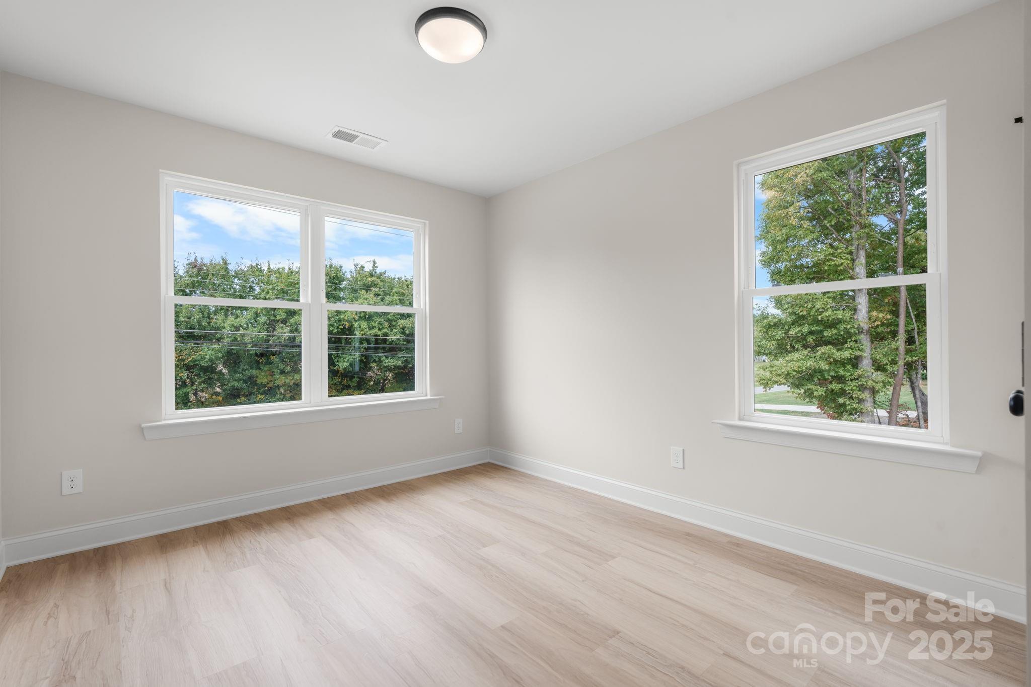 1888 Sigmon Dairy Road Newton, NC 28658 - Photo 19 of 38 an empty room with wooden floor and windows