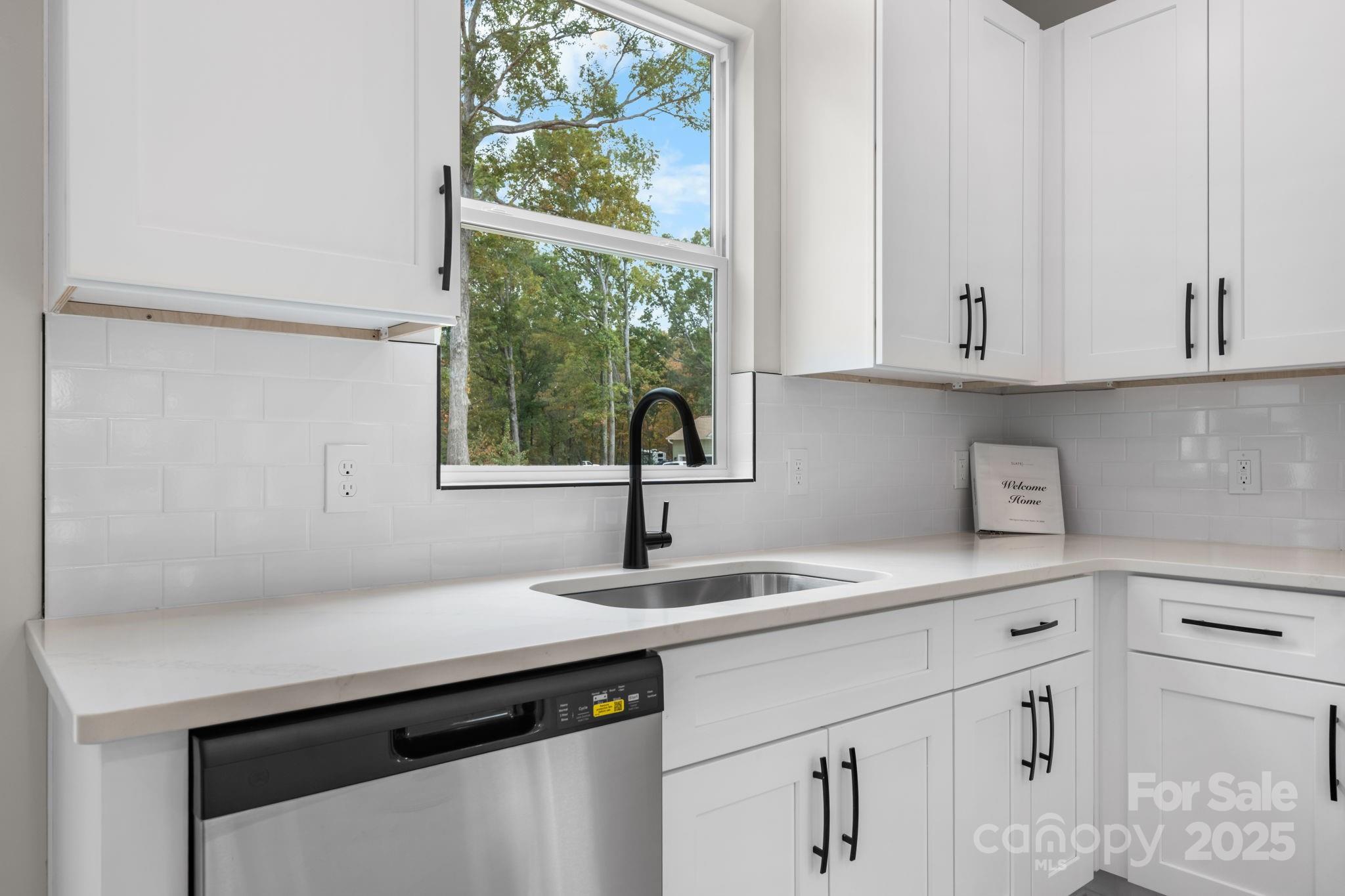 1888 Sigmon Dairy Road Newton, NC 28658 - Photo 5 of 38 a kitchen with white cabinets and a window