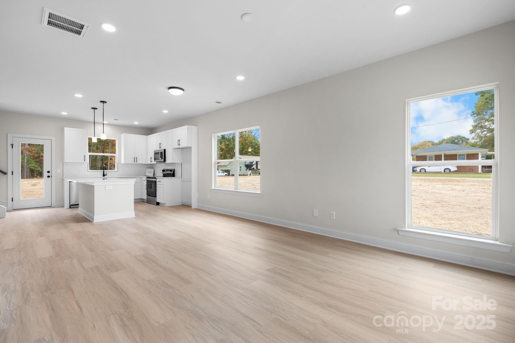 1888 Sigmon Dairy Road Newton, NC 28658 - Photo 7 of 38 a view of empty room with wooden floor and windows