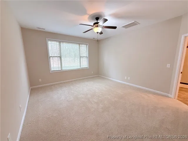 a view of a livingroom with a ceiling fan and window