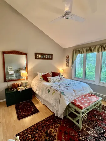 a bedroom with a bed and wooden floor