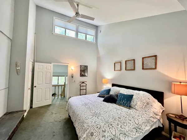 a bedroom with a large bed and a chandelier