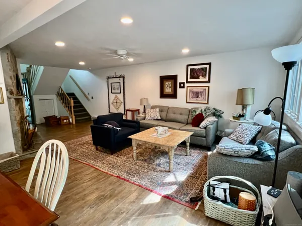 a living room with furniture and wooden floor