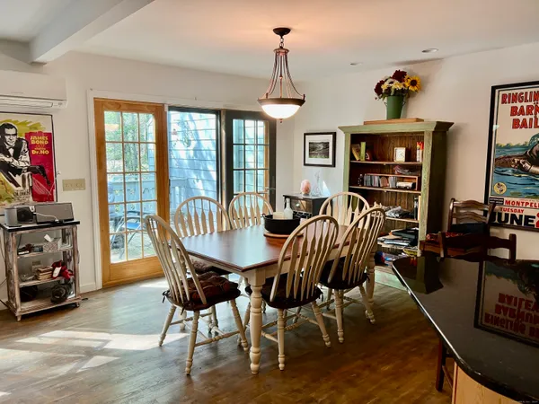 a view of a dining room with furniture window and wooden floor