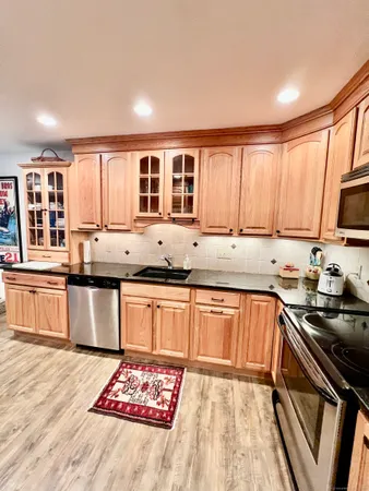 a kitchen with stainless steel appliances granite countertop a stove sink and cabinets
