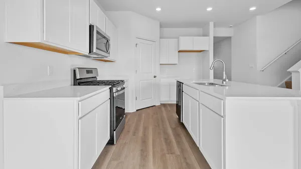 a kitchen with stainless steel appliances granite countertop a sink and a stove