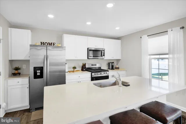 a kitchen with refrigerator and window