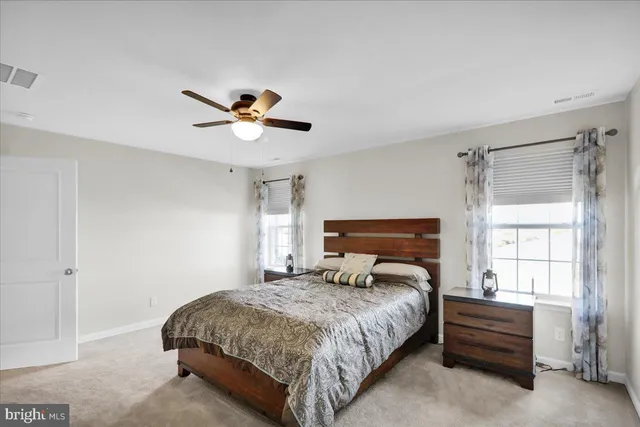 a bedroom with a bed and a ceiling fan
