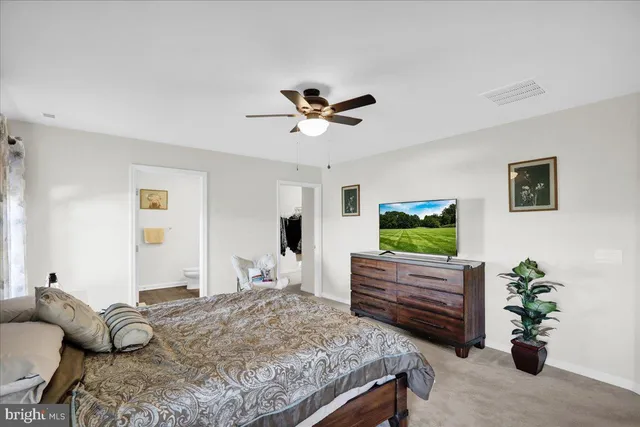 a bedroom with bed and a chandelier