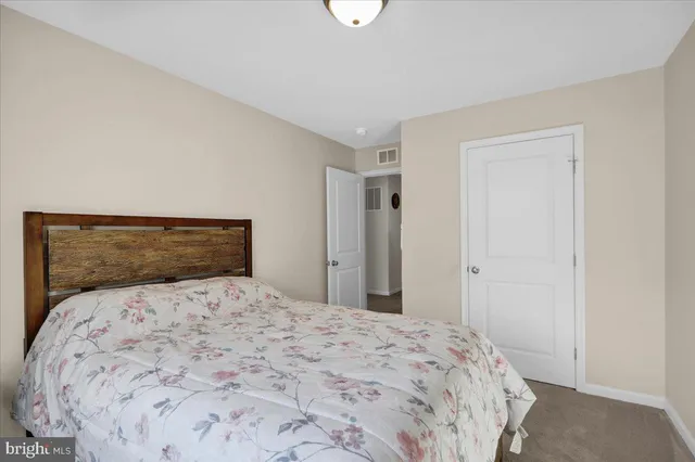 a large bed sitting in a bedroom next to a bathroom