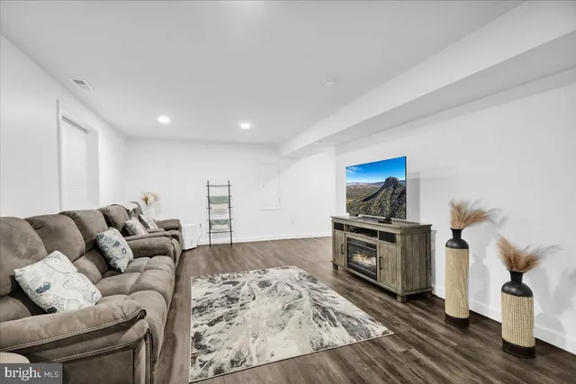 a living room with furniture and a stove