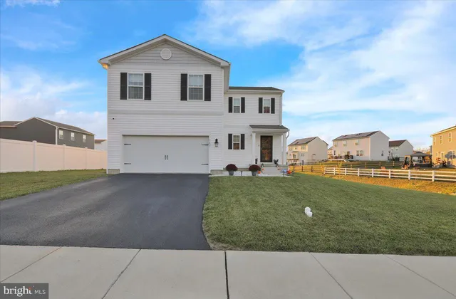 a view of a white house with a yard