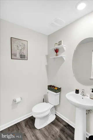 a bathroom with a toilet a sink and mirror