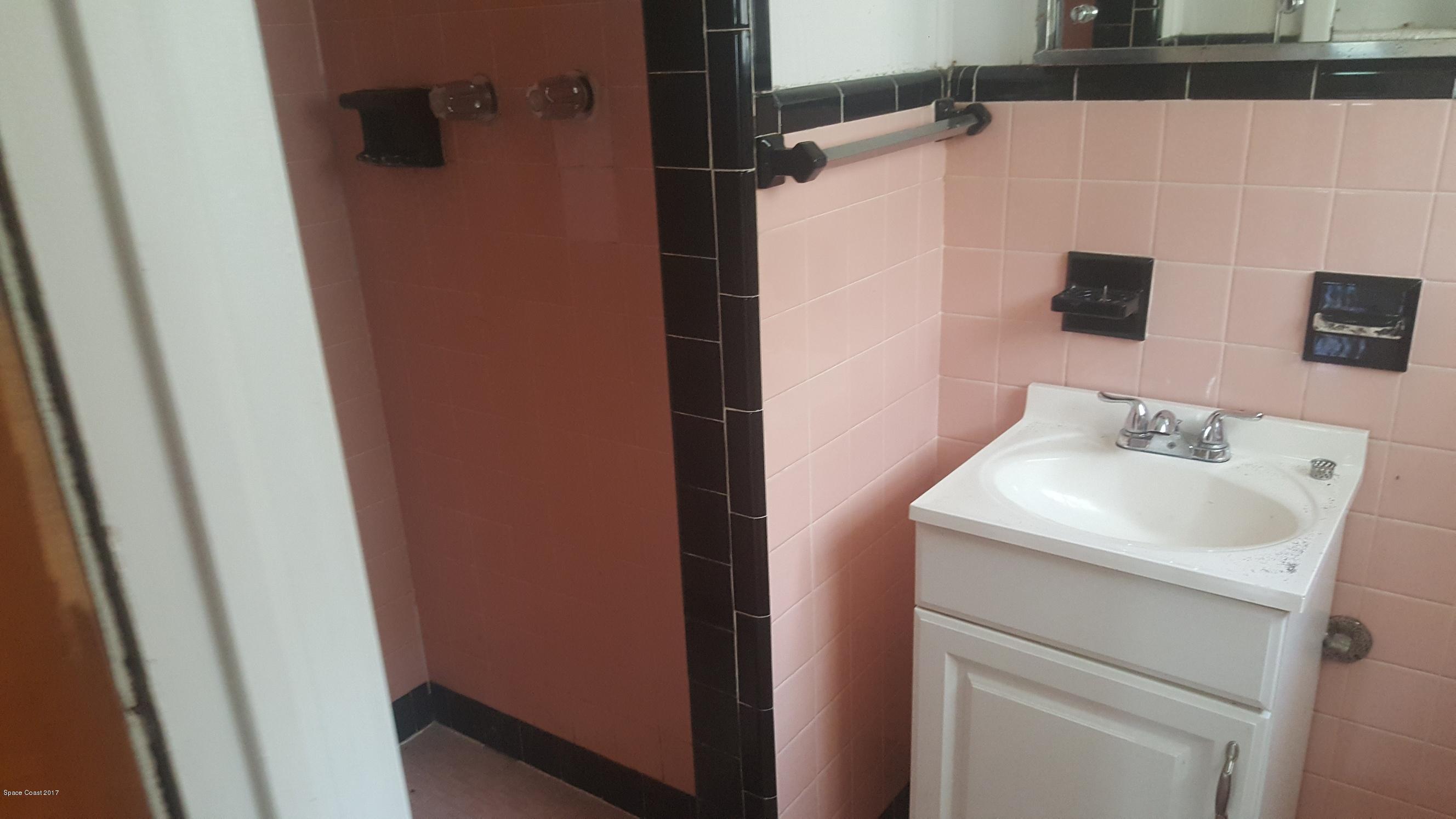 1220 Fern Street Cocoa, FL 32922 - Photo 3 of 4 a bathroom with a sink and a mirror