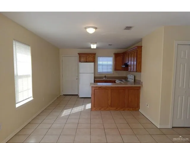 a large kitchen with stainless steel appliances granite countertop a sink and cabinets