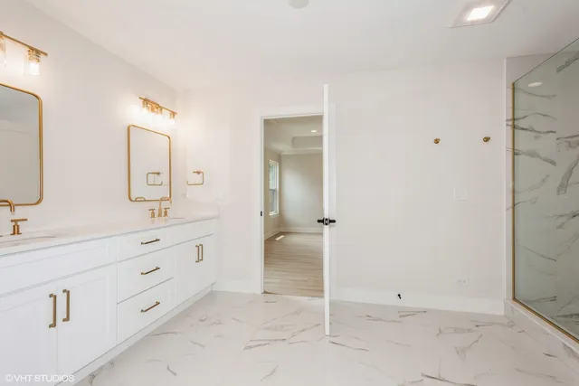 a spacious bathroom with a double vanity sink mirror and double