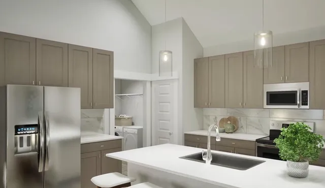 a kitchen with kitchen island a sink stainless steel appliances and cabinets