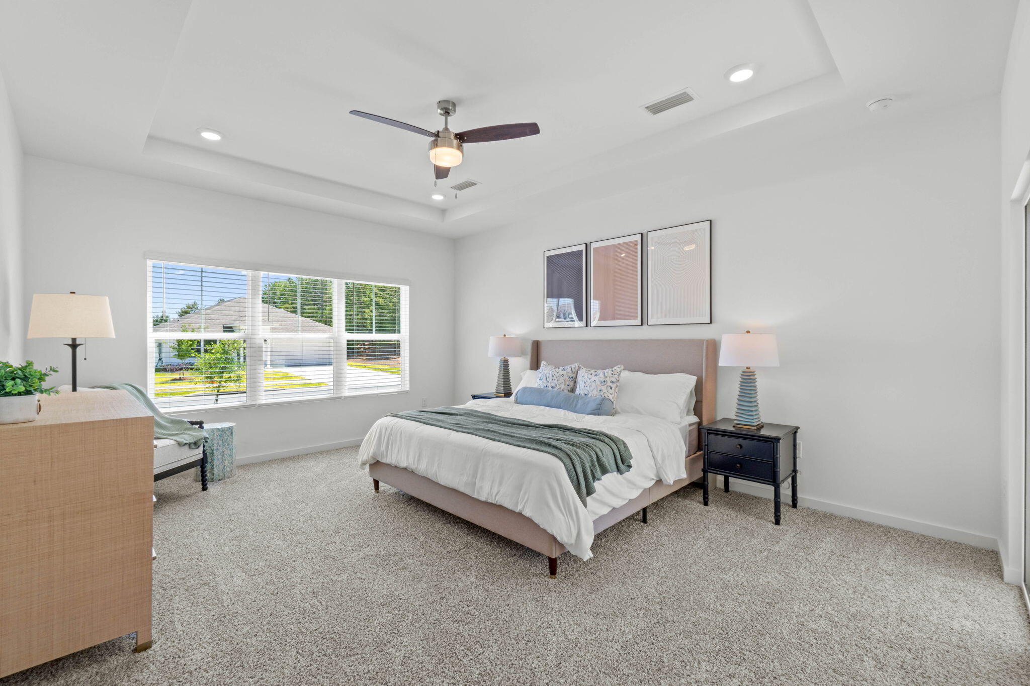 165 Sweetclover Street Freeport, FL 32439 - Photo 21 of 34 a spacious bedroom with a bed couch and a window